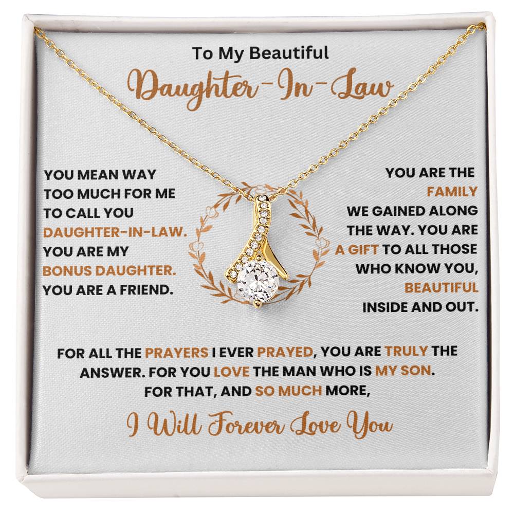 Alluring Beauty necklace in gift box with message for daughter-in-law, featuring a gold pendant on a chain with a heartfelt note