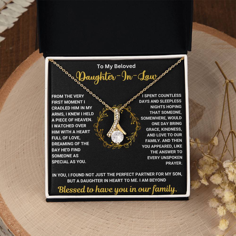 To My Beloved Daughter In Law Alluring Beauty Necklace with heartfelt message in a gift box on a wooden table