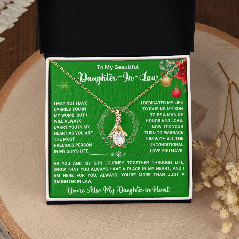 Christmas Alluring Beauty necklace gift for daughter-in-law with heartfelt message, ribbon-shaped pendant in open box.