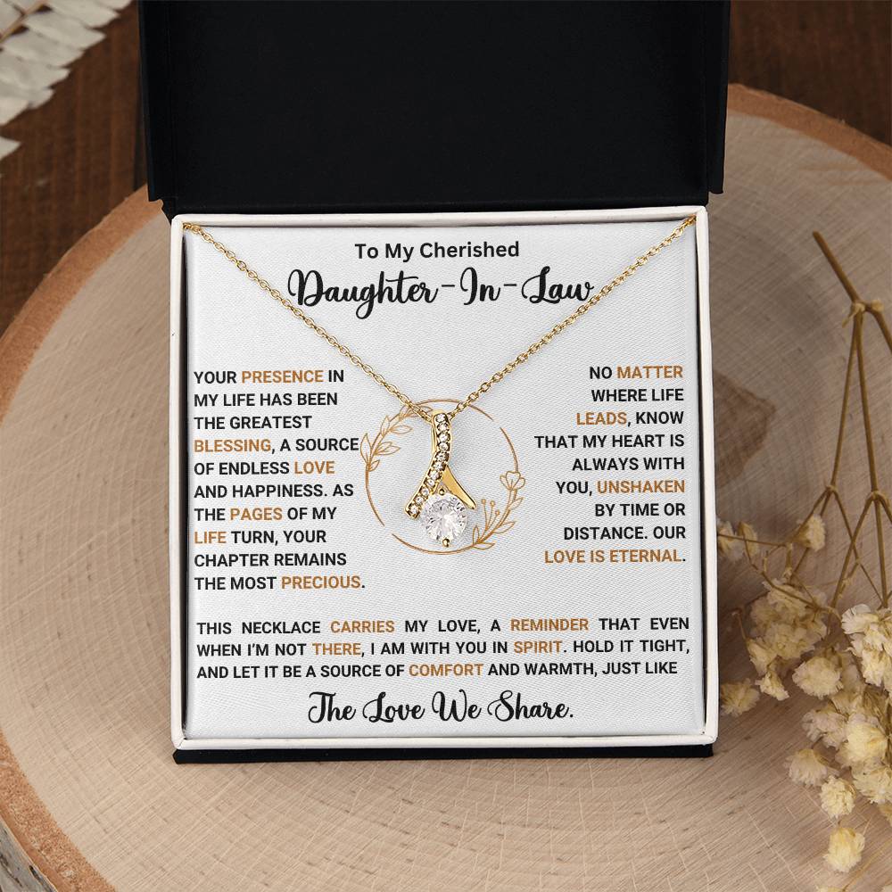 Alluring Beauty necklace with heartfelt message for daughter-in-law, featuring a ribbon-shaped pendant on a jewelry gift box.