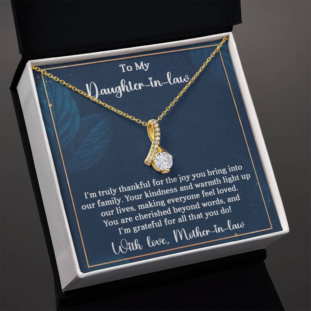 Alluring Beauty necklace for daughter-in-law with heartfelt message in gift box, featuring a ribbon-shaped pendant and sparkling gemstone.