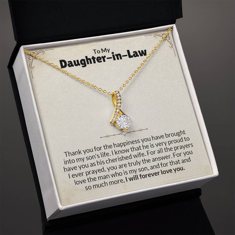 Gold necklace with ribbon pendant in a box labeled "To My Daughter-in-Law," featuring a heartfelt message.