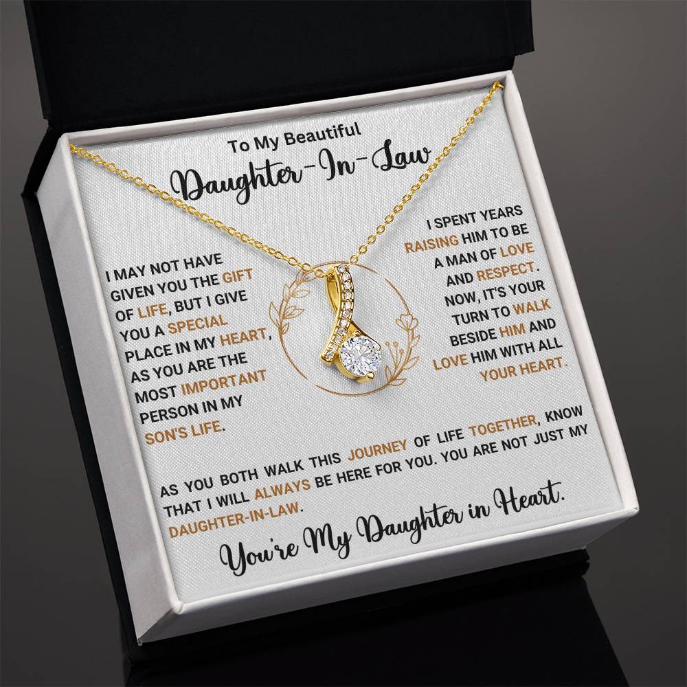 Alluring Beauty necklace in gift box for daughter-in-law with heartfelt message and ribbon-shaped pendant.