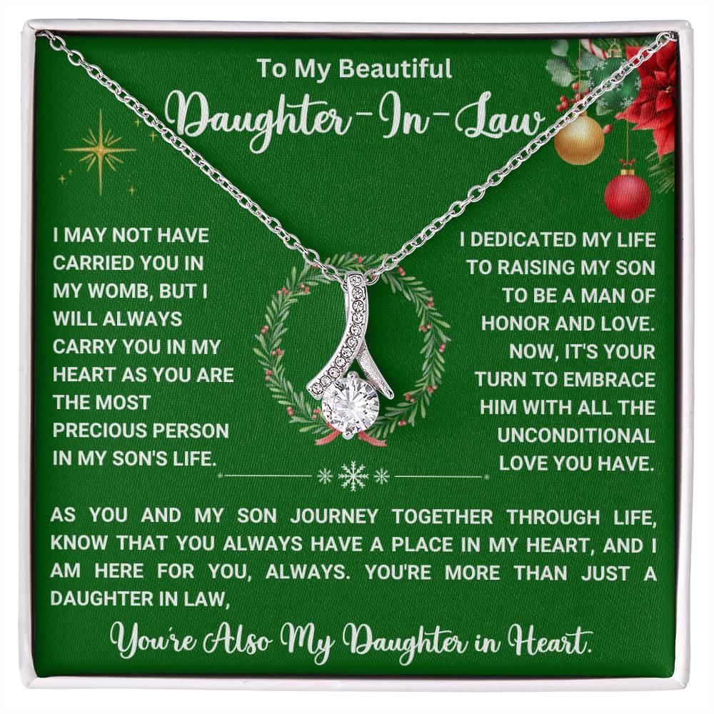 "Alluring Beauty necklace with heartfelt message for daughter-in-law on a green background, featuring a ribbon-shaped pendant"