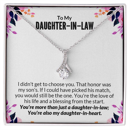 Alluring Beauty necklace gift box with heartfelt message for daughter-in-law, featuring a ribbon-shaped pendant on a floral background.