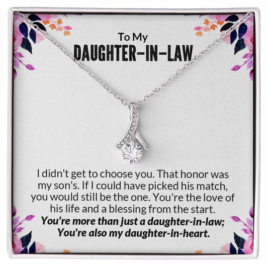 Alluring Beauty necklace gift box with heartfelt message for daughter-in-law, featuring a ribbon-shaped pendant on a floral background.