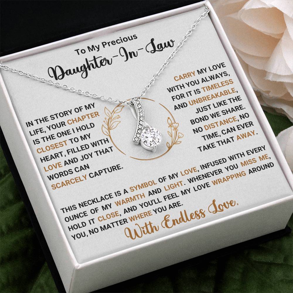 Elegant necklace gift for daughter-in-law with heartfelt message and ribbon pendant in gift box.