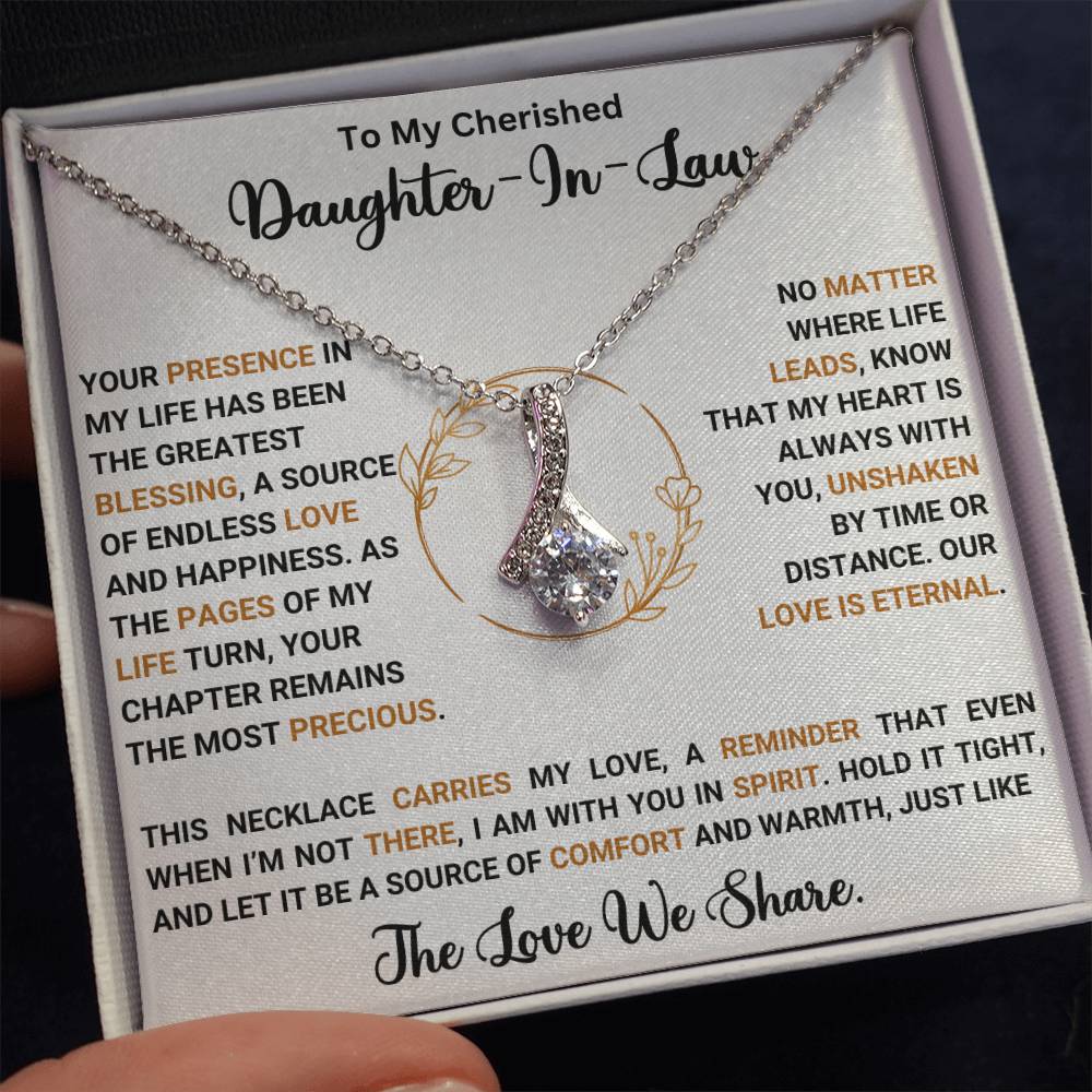 Alluring Beauty necklace with heartfelt message for daughter-in-law, featuring ribbon-shaped pendant in a gift box.