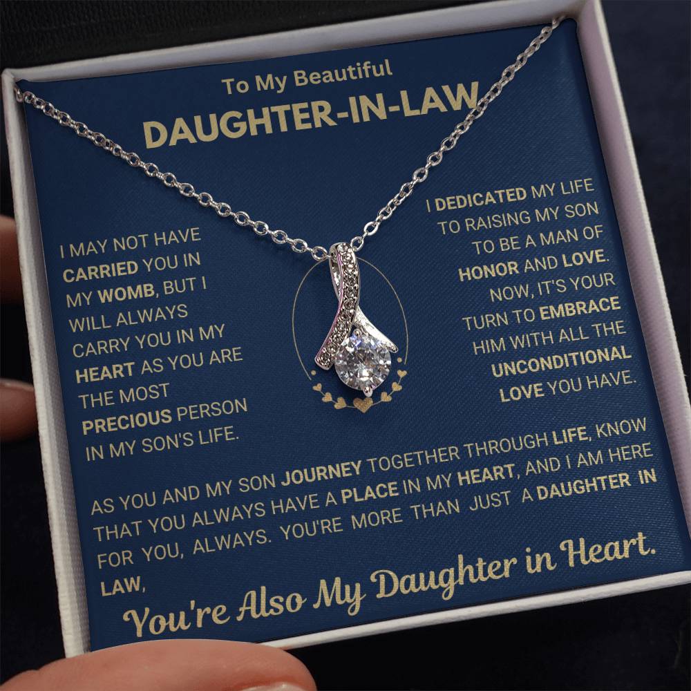 Alluring Beauty necklace with ribbon shaped pendant in gift box, perfect for daughter-in-law, featuring heartfelt message.