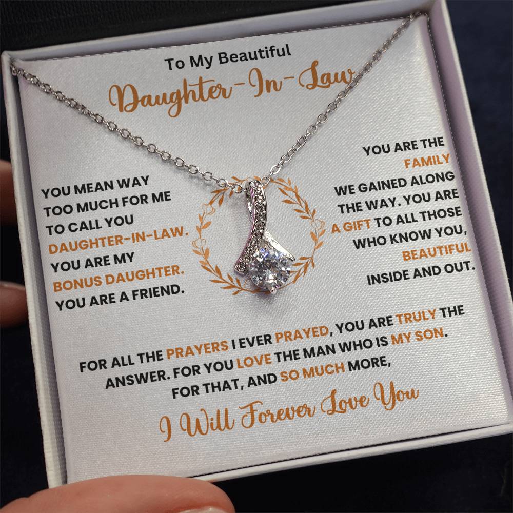 Alluring Beauty necklace for daughter-in-law with ribbon-shaped pendant in gift box with a heartfelt message. 14k white gold or 18k yellow gold finish.