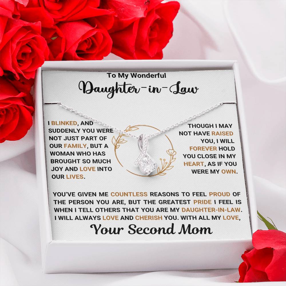 "Alluring Beauty necklace with message card for daughter-in-law, surrounded by red roses, in gift box."