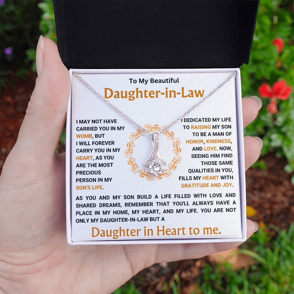 Alluring Beauty necklace gift for daughter-in-law with heartfelt message in white background box held by hand