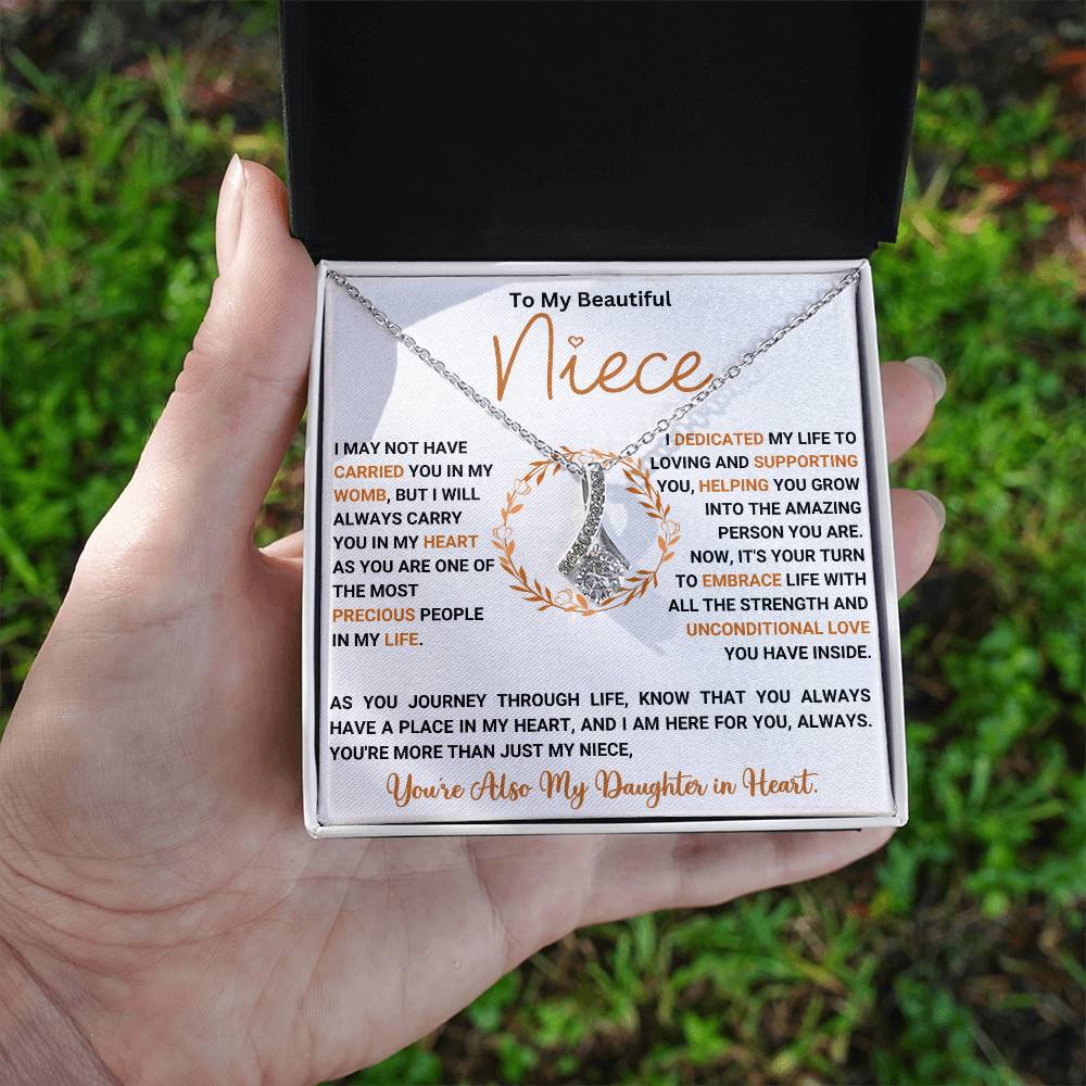 Alluring Beauty necklace gift box for niece with heartfelt message and ribbon-shaped pendant.