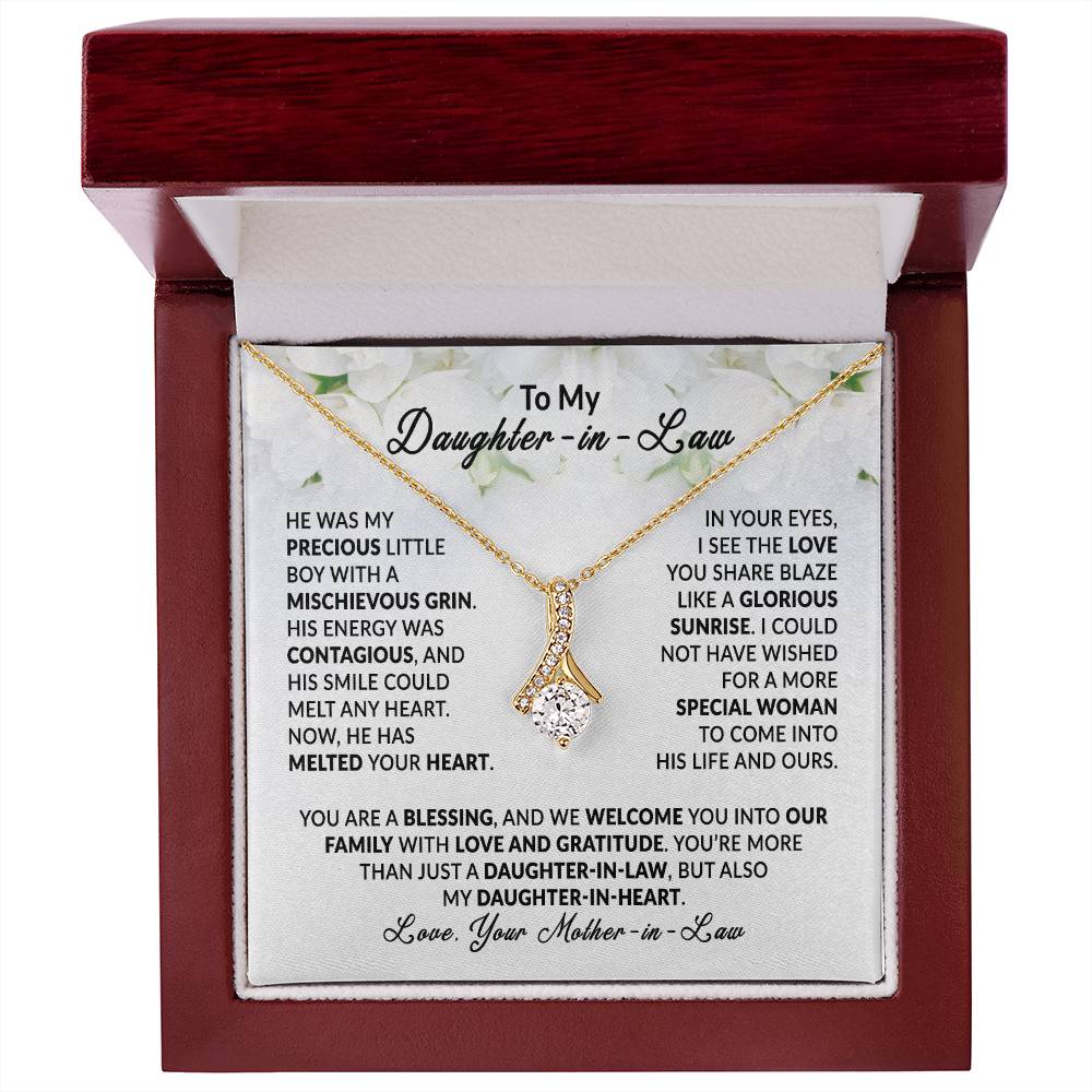 Alluring Beauty necklace in gift box with heartfelt message for daughter-in-law, featuring elegant gold pendant on display.