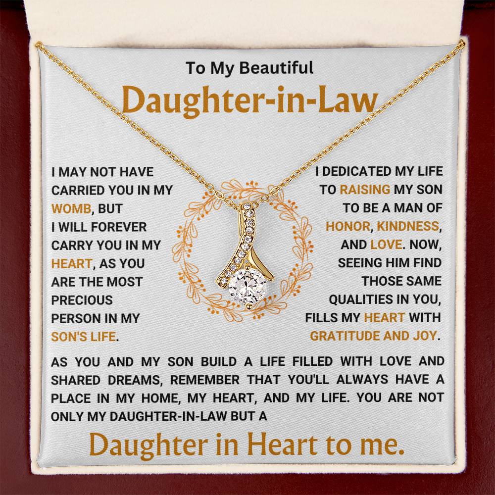 Alluring Beauty necklace gift box with heartfelt message for daughter-in-law, featuring a ribbon-shaped pendant with gold finish.