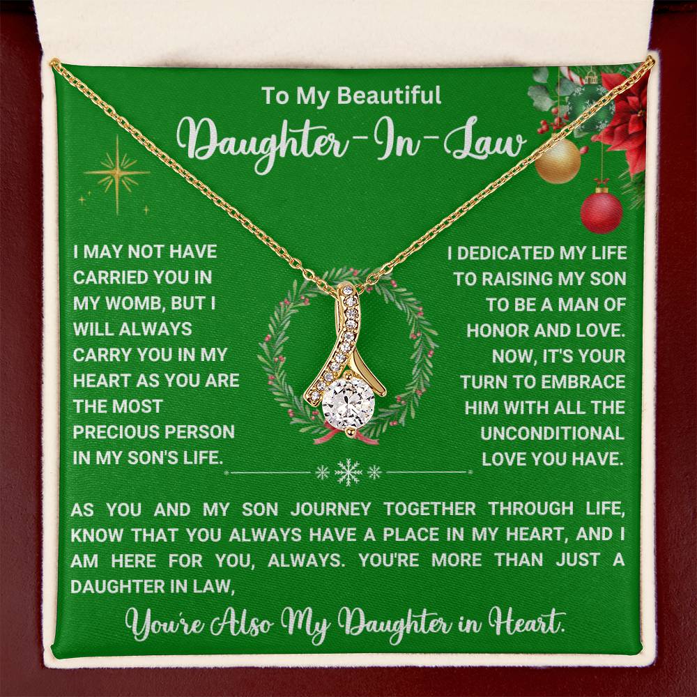 Christmas necklace gift for daughter-in-law with heartfelt message and ribbon-shaped pendant on green background.