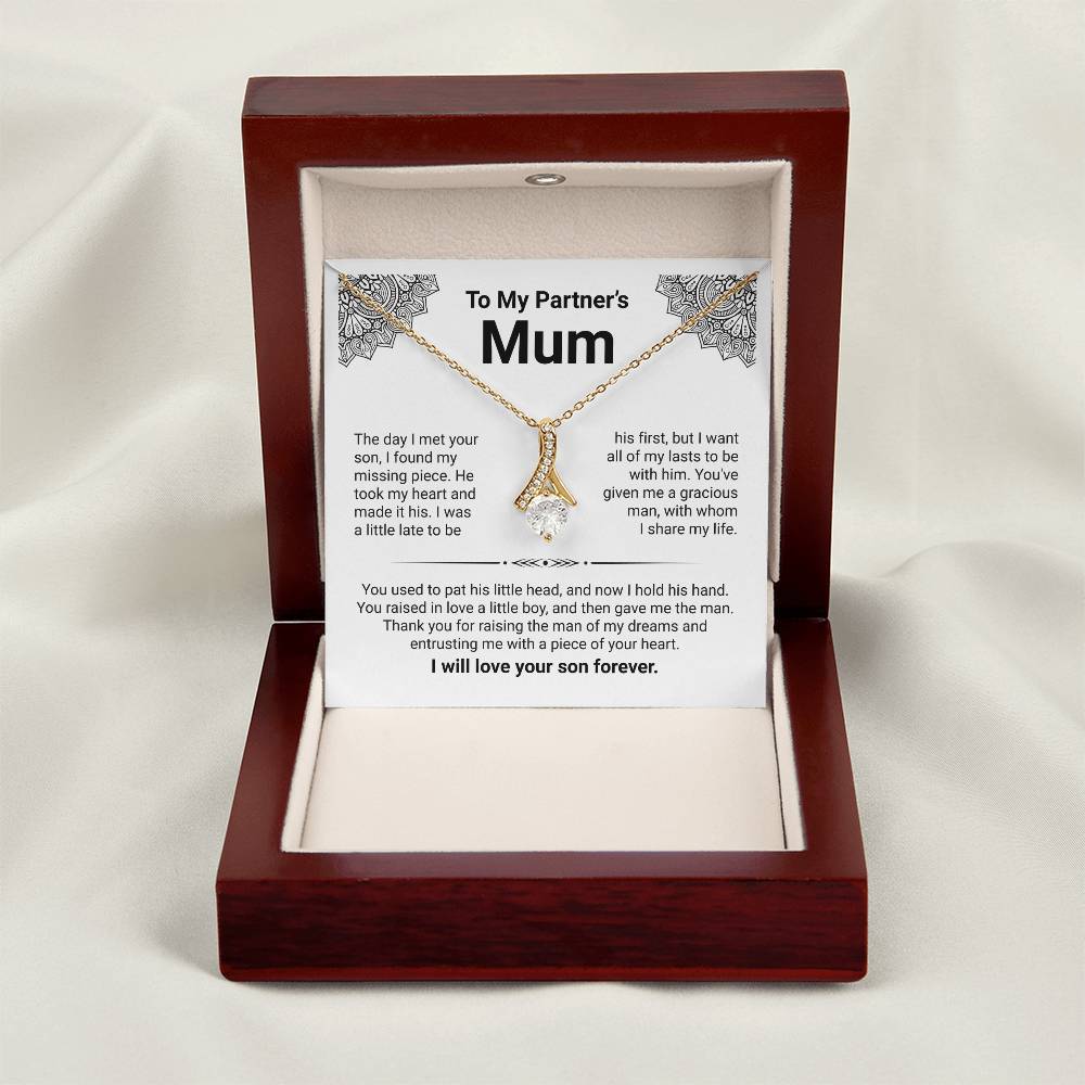 Gold ribbon pendant necklace in a gift box with heartfelt message for partner's mum. Perfect appreciation gift.