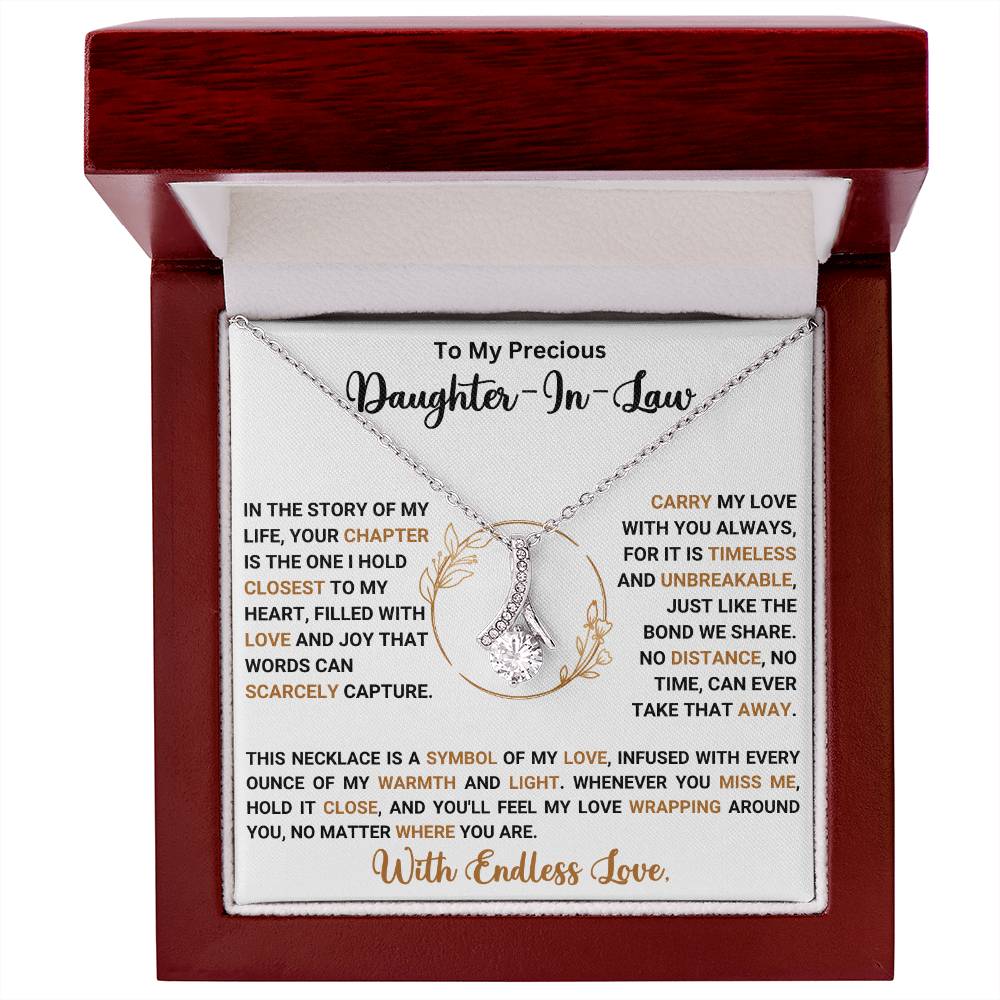 Alluring Beauty Necklace gift box with heartfelt message for daughter-in-law, featuring a ribbon-shaped pendant in a wooden box.