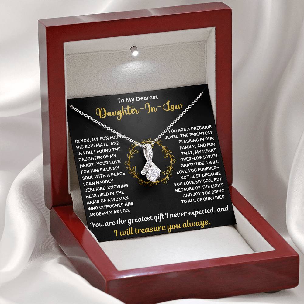 Alluring Beauty necklace gift for daughter-in-law in elegant wooden box with heartfelt message, black and gold card background.