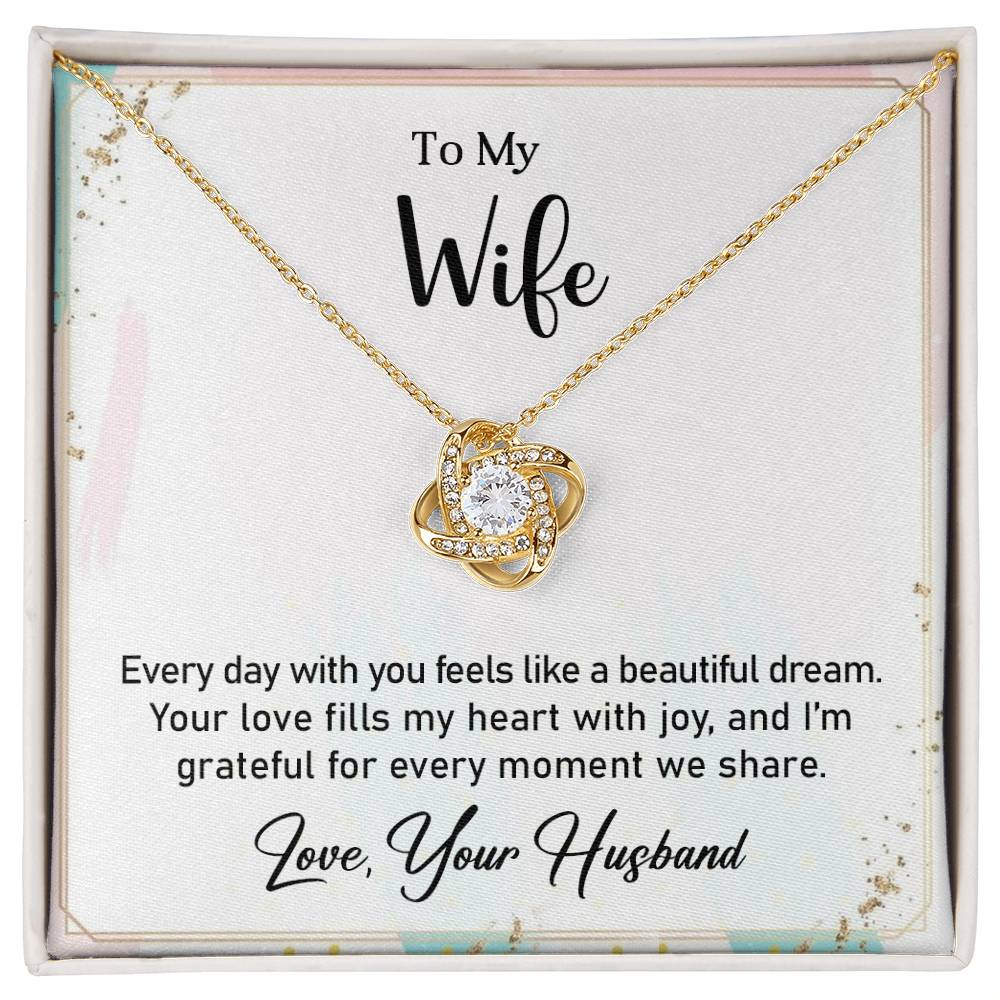 Love Knot Necklace with heartfelt message card for wife, featuring clear cubic zirconia crystals and gold finish.