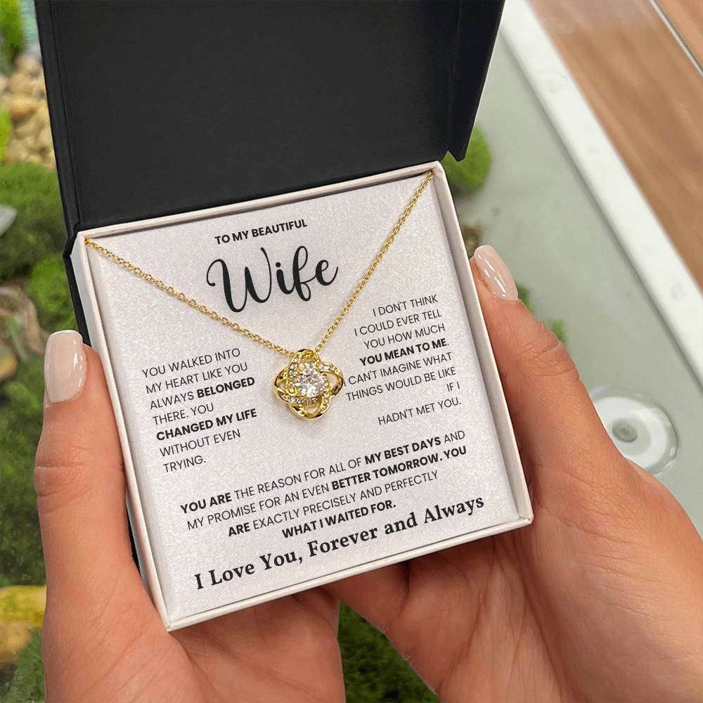 Woman holding love knot necklace with a heartfelt message to wife engraved in the box that says "I love you, forever and always"