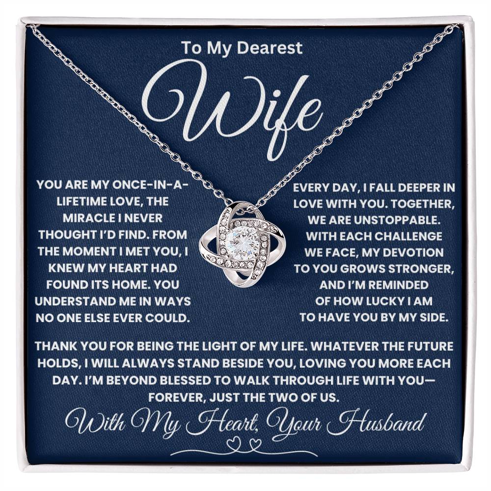 Love Knot Necklace with heartfelt message for wife, featuring cubic zirconia on a chain, in a navy blue gift box.