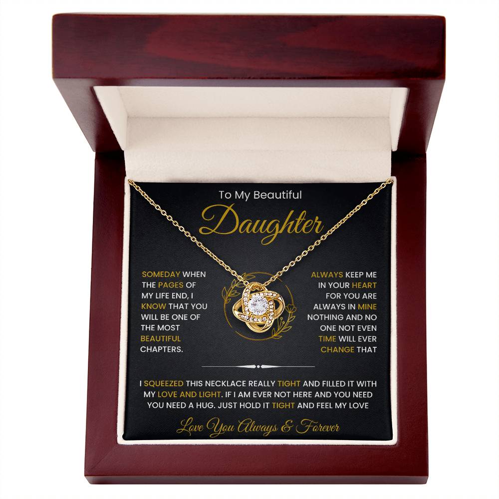 To My Beautiful Daughter Love Knot Necklace with cubic zirconia crystals, presented in a gift box with a heartfelt message from mom and dad.