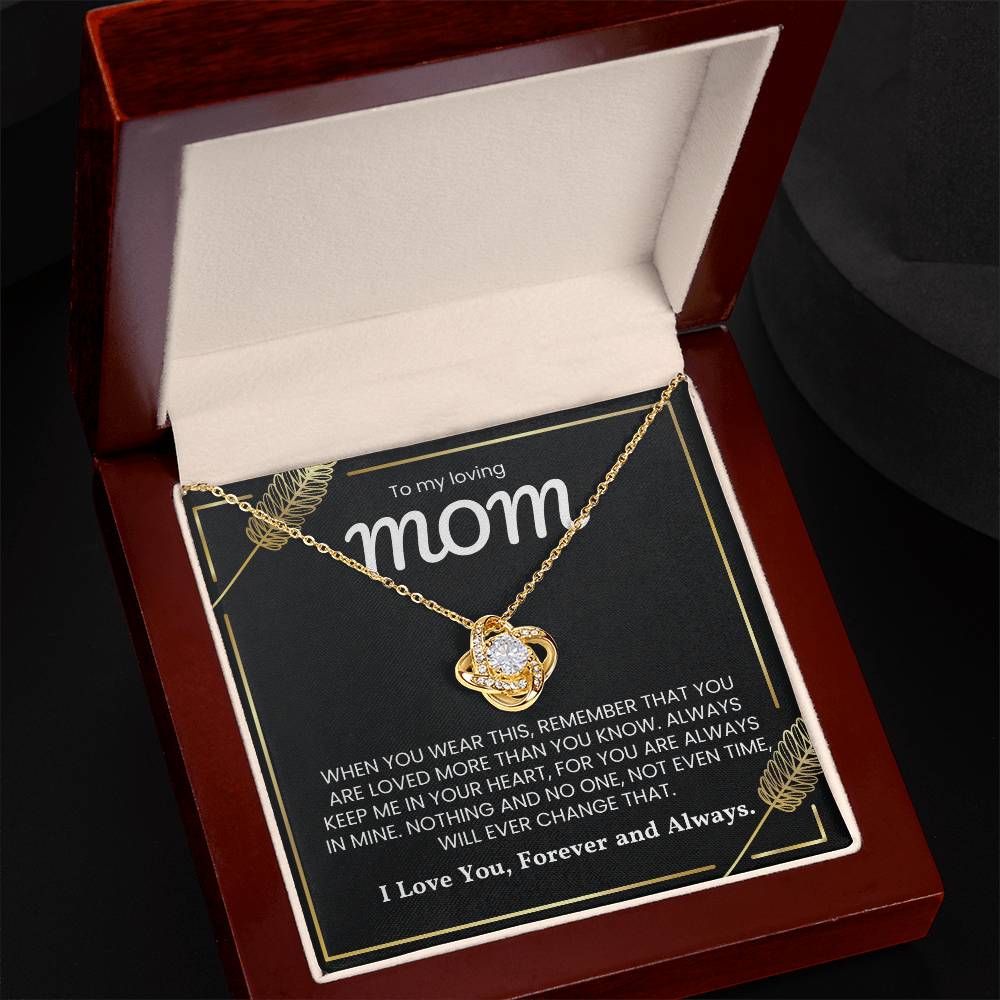 Love Knot Necklace for Mom with heartfelt message, displayed in a wooden box. Perfect gift symbolizing the unbreakable bond.