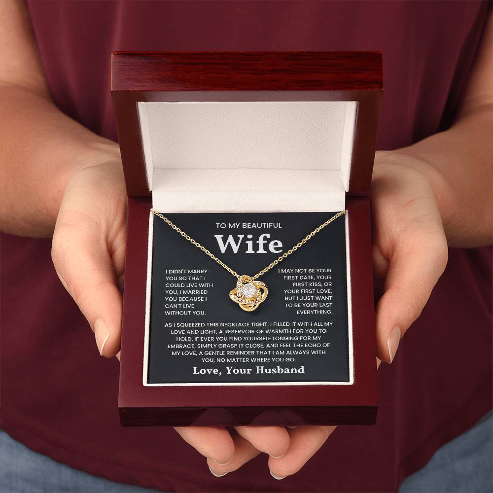 Hands holding a jewelry box with a Love Knot Necklace and message card to a beautiful wife from her husband.