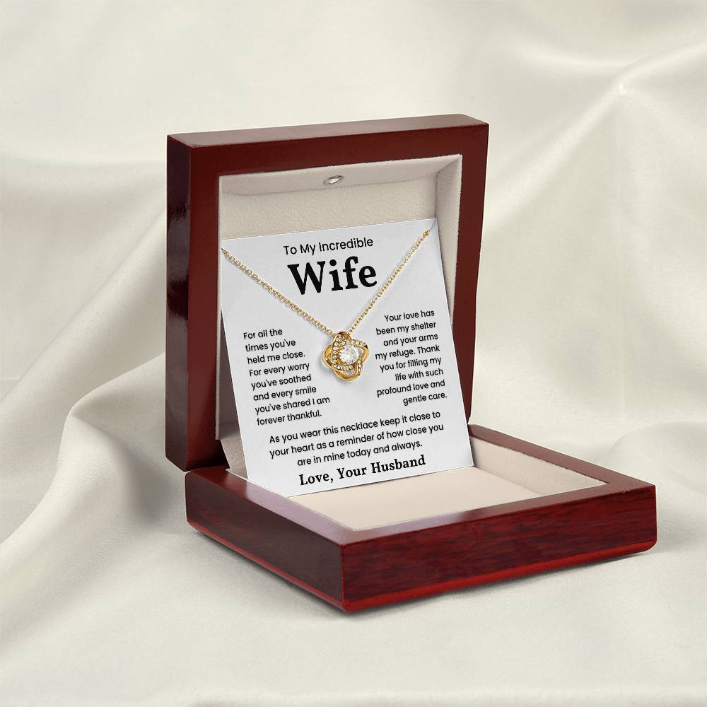 Gold love knot necklace for wife in a wooden box, with a heartfelt message expressing gratitude and love.