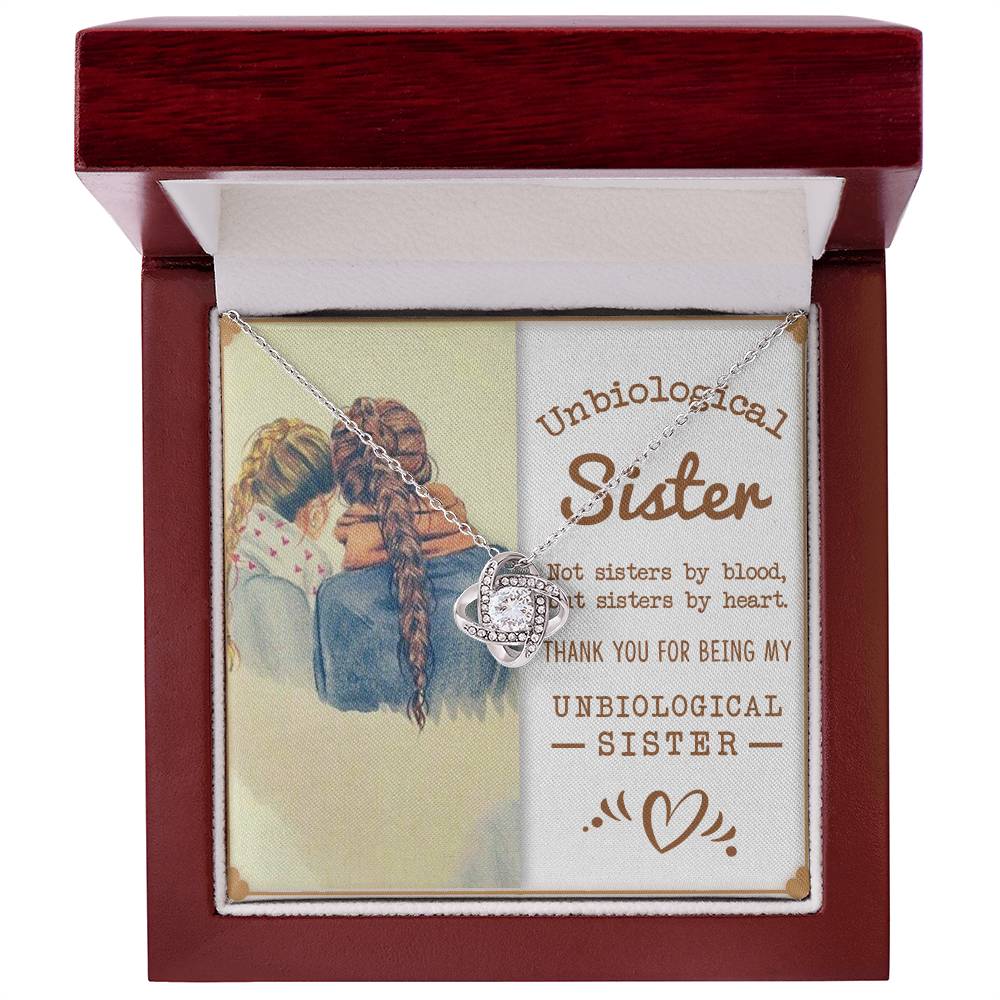 Love Knot Necklace in wooden box with 'To My Unbiological Sister' message, featuring premium cubic zirconia crystals.