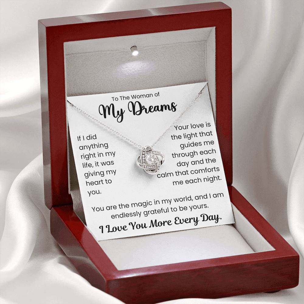 Love Knot Necklace in a wooden box with a romantic message card saying "To The Woman of My Dreams. I Love You More Every Day."