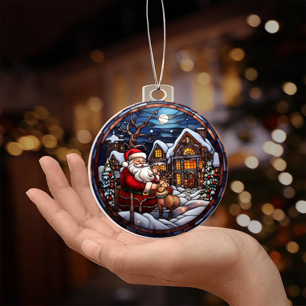 Christmas acrylic ornament with Santa and reindeer in a snowy village, held in hand, perfect for holiday decor.