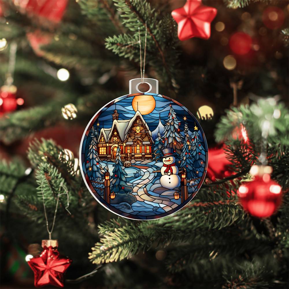 Christmas acrylic ornament featuring a snowman and cozy cottage on snowy night, hanging on a decorated Christmas tree.