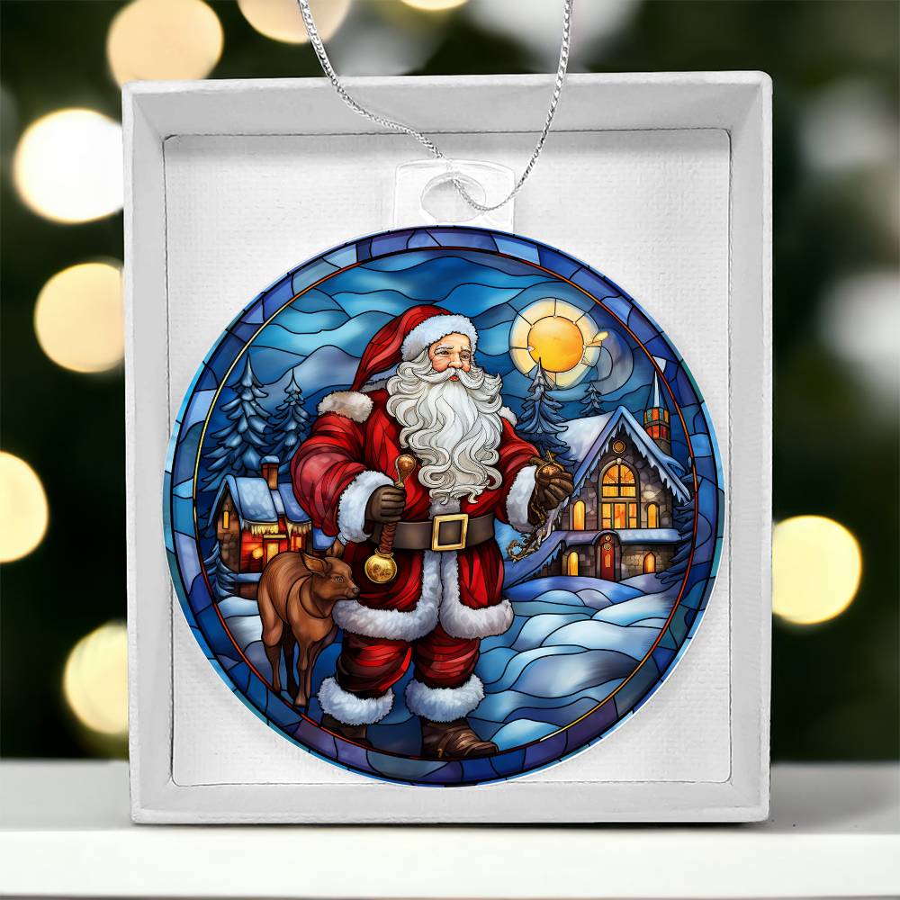 Christmas acrylic ornament featuring Santa with a cozy cabin and snow-covered trees, glowing under a winter sunset sky.