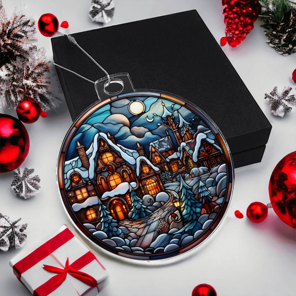 Christmas acrylic ornament with a moonlit village scene, surrounded by festive decorations and gift box.