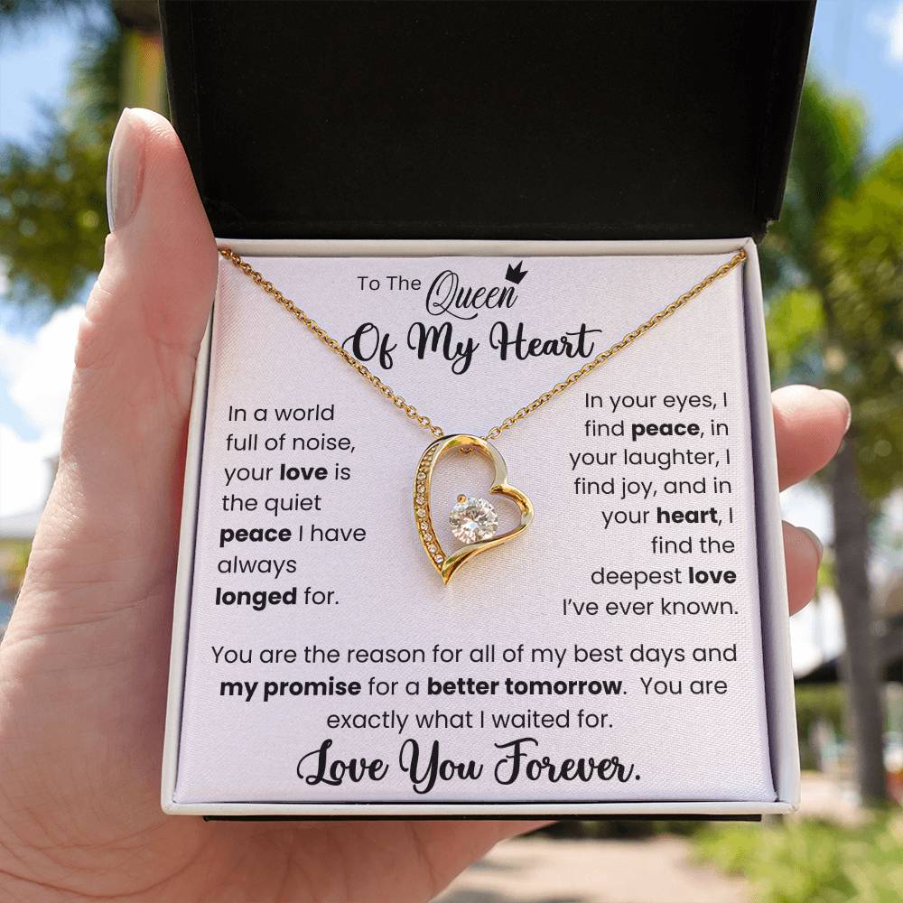 "To The Queen of My Heart Forever Love Necklace with Gold Heart Pendant and CZ Crystal in a Gift Box Held by Hand"