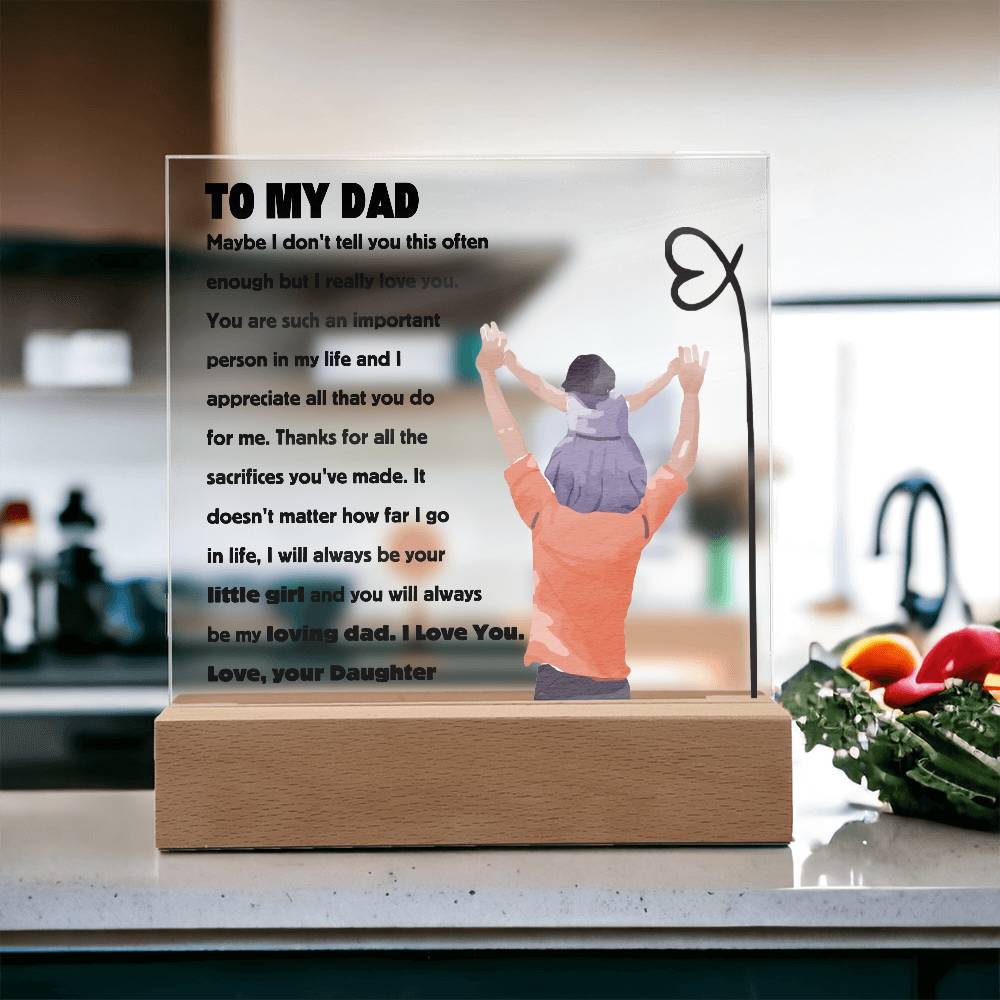 Square acrylic plaque with a heartfelt message to dad from daughter, displayed on a kitchen countertop with blurred background