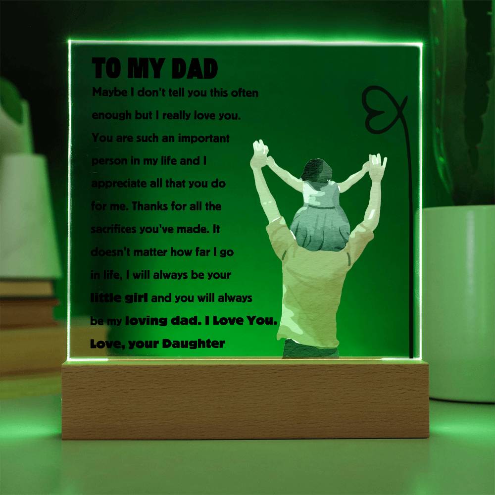 Square acrylic plaque with heartfelt message to dad, featuring an image of a dad carrying a daughter on his shoulders, set on a wooden base.