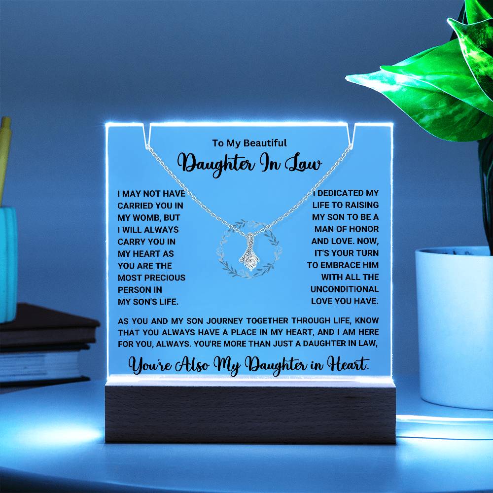 Keepsake acrylic with touching message for daughter-in-law, featuring necklace, illuminated on wooden base. Perfect heartfelt gift.