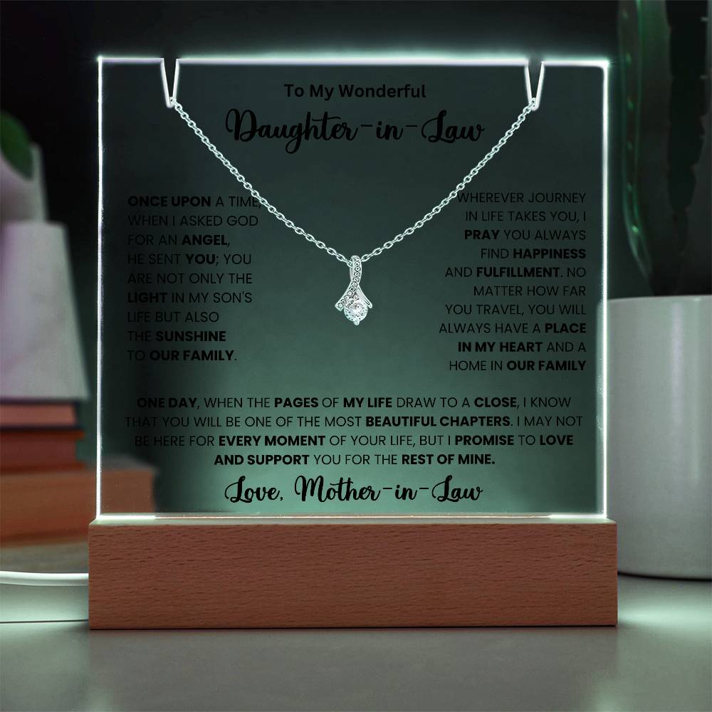 Keepsake acrylic necklace with heartfelt message from mother-in-law to daughter-in-law on illuminated display.